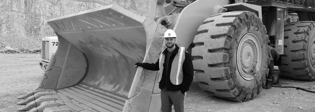 Utility worker standing next to bulldozer